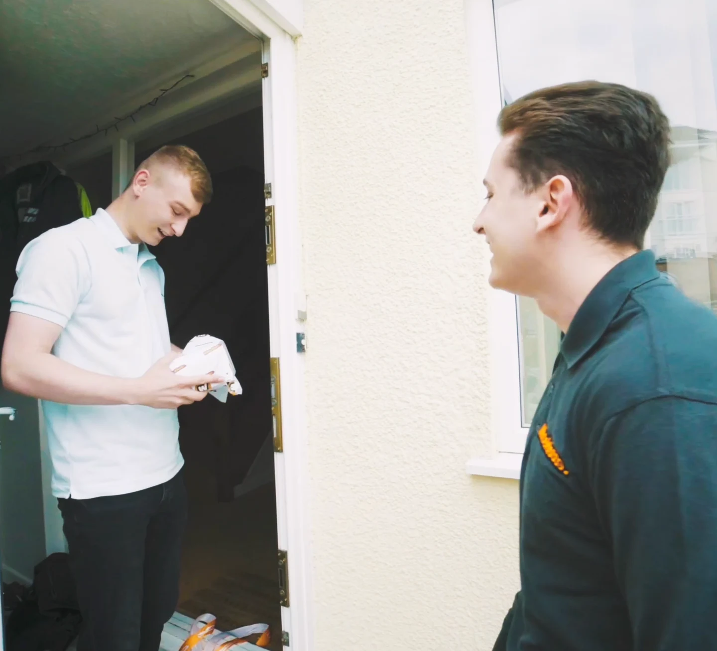 Owen Simmonds receiving his prize from Harrison at his doorway in Plymouth
